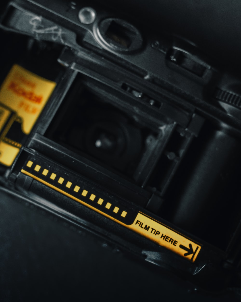 a close up of a camera with a yellow sticker on it