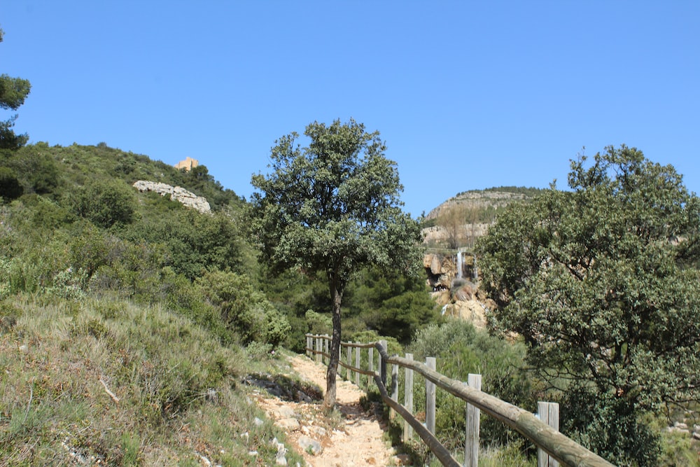 a wooden fence on the side of a hill